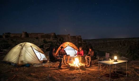 Camping tents pitched against a scenic canyon backdrop