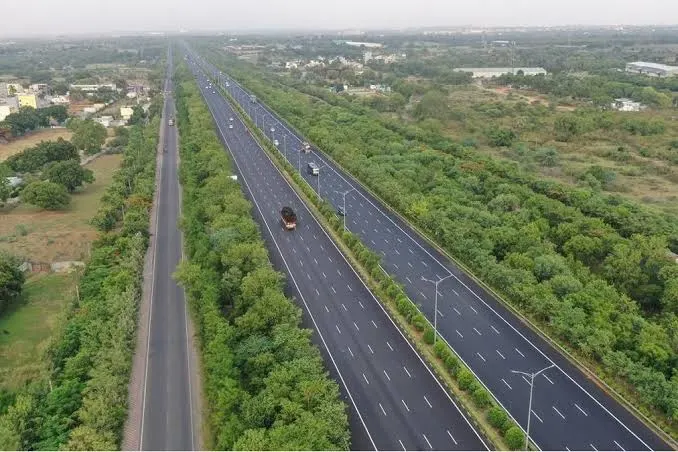 A serene Indian highway passing through green farmlands